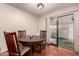 Cozy dining area with tile flooring, a round table, and sliding glass door to the backyard at 9511 W Carol Ave, Peoria, AZ 85345