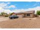 Charming single-story brick home with a two car garage and a desert-landscaped front yard at 9511 W Carol Ave, Peoria, AZ 85345