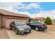 Single-story brick home featuring a two-car garage, desert landscaping, and driveway parking at 9511 W Carol Ave, Peoria, AZ 85345