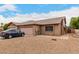 Charming single-story brick home with a two car garage and a desert-landscaped front yard at 9511 W Carol Ave, Peoria, AZ 85345