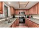 A charming kitchen with stainless steel appliances, granite countertops, and natural light at 9511 W Carol Ave, Peoria, AZ 85345