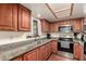 Well-lit kitchen featuring granite countertops, stainless steel appliances, and ample cabinet space at 9511 W Carol Ave, Peoria, AZ 85345