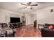 Bright living room featuring tile flooring, a ceiling fan, and a comfortable seating area at 9511 W Carol Ave, Peoria, AZ 85345