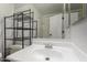 All-white bathroom with a mirror, sink, vanity, toilet and walk-in shower at 10101 N Arabian Trl # 2018, Scottsdale, AZ 85258