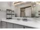 Clean bathroom featuring a sink with cabinet, large mirror, and enclosed shower at 10101 N Arabian Trl # 2018, Scottsdale, AZ 85258