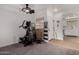 Bonus space with neutral tones adjacent to a kitchen with white cabinetry at 10101 N Arabian Trl # 2018, Scottsdale, AZ 85258