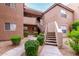 Well-maintained building exterior with concrete stairs and desert landscaping at 10101 N Arabian Trl # 2018, Scottsdale, AZ 85258