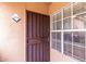 Secured front door entry with barred security door and sidelight window allowing natural light at 10101 N Arabian Trl # 2018, Scottsdale, AZ 85258