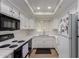 Well-lit kitchen showcasing white cabinets, subway tile backsplash, appliances, and ample counter space at 10101 N Arabian Trl # 2018, Scottsdale, AZ 85258