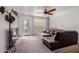 Cozy living room features neutral carpet, fan and a door leading to a patio at 10101 N Arabian Trl # 2018, Scottsdale, AZ 85258