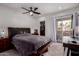 Inviting main bedroom features a ceiling fan, closet, and sliding glass doors to the patio at 10101 N Arabian Trl # 2018, Scottsdale, AZ 85258