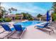 Relaxing community pool featuring lounge chairs and mature shade trees at 10101 N Arabian Trl # 2018, Scottsdale, AZ 85258