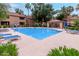 Community pool with lounge chairs, a covered area, and beautiful landscaping create a resort-like atmosphere at 10101 N Arabian Trl # 2018, Scottsdale, AZ 85258