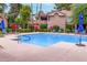 Community pool with clear blue water and comfortable lounge chairs at 10101 N Arabian Trl # 2018, Scottsdale, AZ 85258