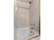 Tiled shower-tub combination features gold trim, glass shower door and shower head at 10101 N Arabian Trl # 2018, Scottsdale, AZ 85258