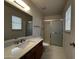 Well-lit bathroom featuring vanity, updated countertop, and glass-enclosed shower at 11022 S Iroquois Dr, Phoenix, AZ 85044