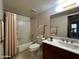 Practical bathroom features a shower-tub combo, vanity with storage, and neutral finishes at 11022 S Iroquois Dr, Phoenix, AZ 85044