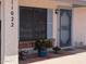 Entrance with front door, potted plants, and security screens on windows at 11022 S Iroquois Dr, Phoenix, AZ 85044