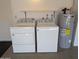 Laundry area features a Whirlpool washer, dryer, and hot water tank at 11022 S Iroquois Dr, Phoenix, AZ 85044