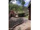 Enjoy the serene backyard oasis with a stone pathway and mature trees offering shade at 11052 N 10Th Pl, Phoenix, AZ 85020
