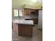 Functional kitchen boasts ample counter space, wooden cabinets, and a bright window view at 11052 N 10Th Pl, Phoenix, AZ 85020