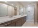 Elegant bathroom featuring a double vanity, quartz countertop and a frameless glass shower at 11300 N Casa Dega Dr # 1081, Surprise, AZ 85388