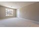 Comfortable bedroom featuring soft carpeting and a sunlit window at 11300 N Casa Dega Dr # 1081, Surprise, AZ 85388