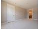 Spacious bedroom with a walk-in closet, neutral carpet and an en-suite bathroom at 11300 N Casa Dega Dr # 1081, Surprise, AZ 85388