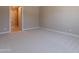 A bright bedroom with neutral carpeting and an en-suite bathroom at 11300 N Casa Dega Dr # 1081, Surprise, AZ 85388