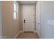 Bright entryway featuring a white door, light wood floors, and neutral-toned walls at 11300 N Casa Dega Dr # 1081, Surprise, AZ 85388