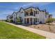 Beautiful townhouse with white exterior, black trim, well-manicured lawn, and sunny blue sky at 11300 N Casa Dega Dr # 1081, Surprise, AZ 85388