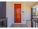 Close-up of the home's vibrant red front door, contrasting with the modern exterior design at 11300 N Casa Dega Dr # 1081, Surprise, AZ 85388
