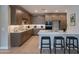 Modern kitchen features stainless steel appliances, quartz countertops, and breakfast bar seating at 11300 N Casa Dega Dr # 1081, Surprise, AZ 85388