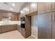 Modern kitchen with an electric cooktop, stainless steel appliances and wood floors at 11300 N Casa Dega Dr # 1081, Surprise, AZ 85388
