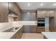 Modern kitchen featuring stainless steel appliances, an electric cooktop and quartz countertops at 11300 N Casa Dega Dr # 1081, Surprise, AZ 85388