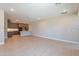 Bright, open-concept space with light wood floors, connecting living and kitchen areas at 11300 N Casa Dega Dr # 1081, Surprise, AZ 85388