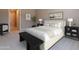 Bright main bedroom with ensuite bathroom featuring a large bed, plants, and carpeted floors at 11300 N Casa Dega Dr # 1081, Surprise, AZ 85388