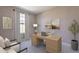Well-lit home office with a large desk, comfortable seating, and neutral tones at 11300 N Casa Dega Dr # 1081, Surprise, AZ 85388