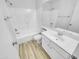 Clean bathroom with tub and shower combo, vanity, and coordinating white fixtures at 1211 S Pueblo Ct, Gilbert, AZ 85233