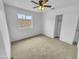Cozy bedroom with a ceiling fan, carpet flooring, and a sliding-door closet at 1211 S Pueblo Ct, Gilbert, AZ 85233