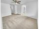 Neutral carpeted bedroom with ceiling fan and multiple doorways creating an airy atmosphere at 1211 S Pueblo Ct, Gilbert, AZ 85233