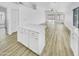 Open concept kitchen with a large island, stainless steel appliances, and wood-look floors at 1211 S Pueblo Ct, Gilbert, AZ 85233
