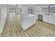 Open concept kitchen with island, quartz countertops, stainless steel appliances, and wood-look floors at 1211 S Pueblo Ct, Gilbert, AZ 85233