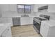 Bright kitchen with white cabinets, stainless steel appliances, and quartz countertops at 1211 S Pueblo Ct, Gilbert, AZ 85233