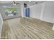 Bright living room with wood-look floors, large window, and blue double-door entryway at 1211 S Pueblo Ct, Gilbert, AZ 85233
