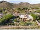 Panoramic aerial view of a luxury home, pool and desert landscape with mountain views at 13249 E Summit Dr, Scottsdale, AZ 85259