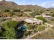 A sprawling estate with pool, covered patios, lush landscaping, and mountain views at 13249 E Summit Dr, Scottsdale, AZ 85259