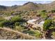 Expansive aerial view of a luxurious home featuring a private putting green and desert landscape at 13249 E Summit Dr, Scottsdale, AZ 85259