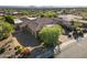 Aerial view showcasing the sprawling estate with multiple garages, lush greenery, and mountain views at 13249 E Summit Dr, Scottsdale, AZ 85259