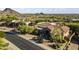 Stunning aerial view showcasing a tile roof home with mature desert landscaping at 13249 E Summit Dr, Scottsdale, AZ 85259